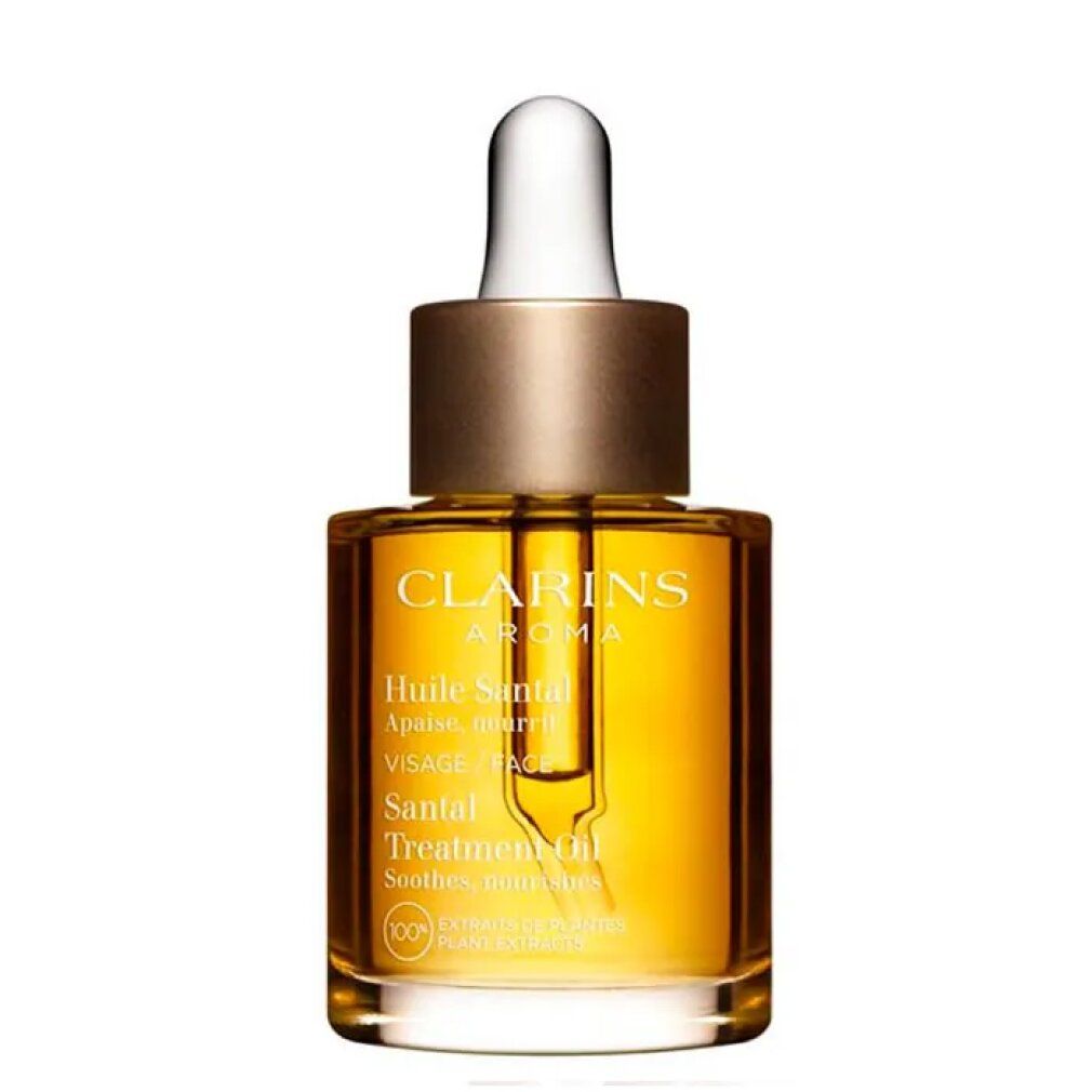 Clarins Aroma Huile Santal. Flacone in vetro con contenuto dorato e contagocce. Etichetta del prodotto visibile.