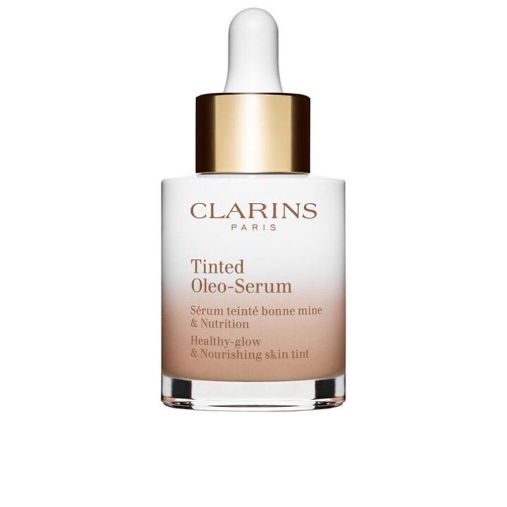 Flacone di siero. Sfumatura bianco-marrone. Tappo dorato. Scritta: Clarins, Tinted Oleo-Serum, Healthy-glow & Nourishing skin tint.
