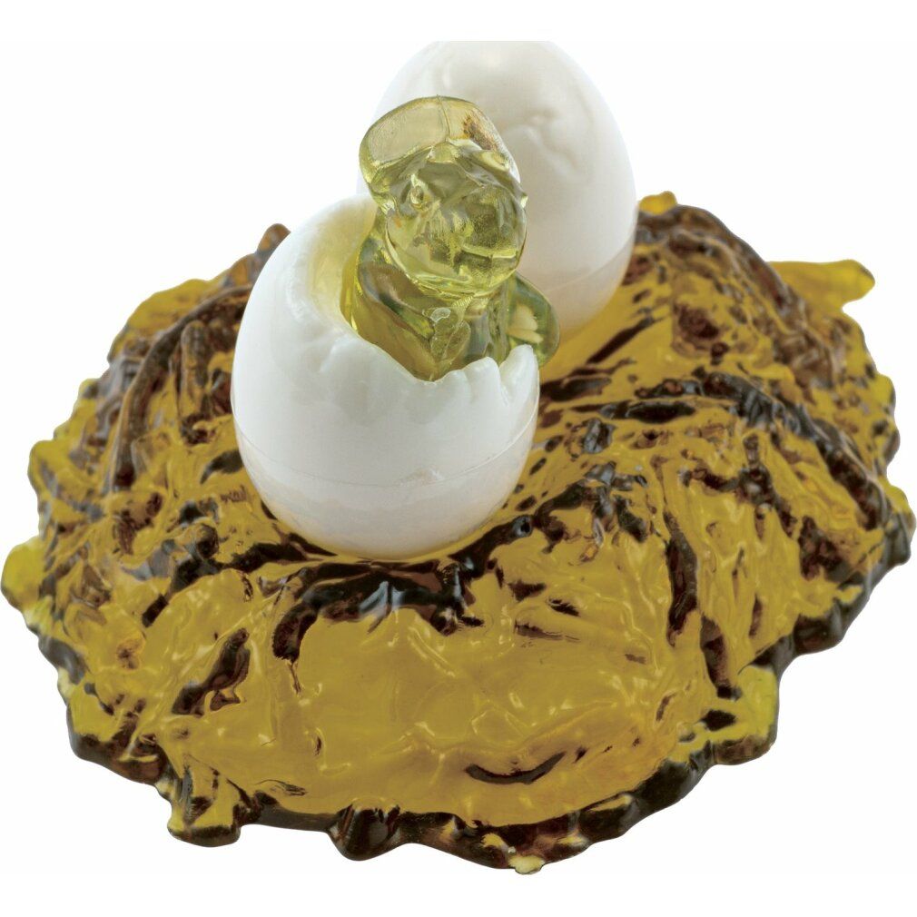 Nido di puzzle di cristallo con due uova, una con dinosauro bambino. Nido giallo-marrone, uova bianche, bambino trasparente.