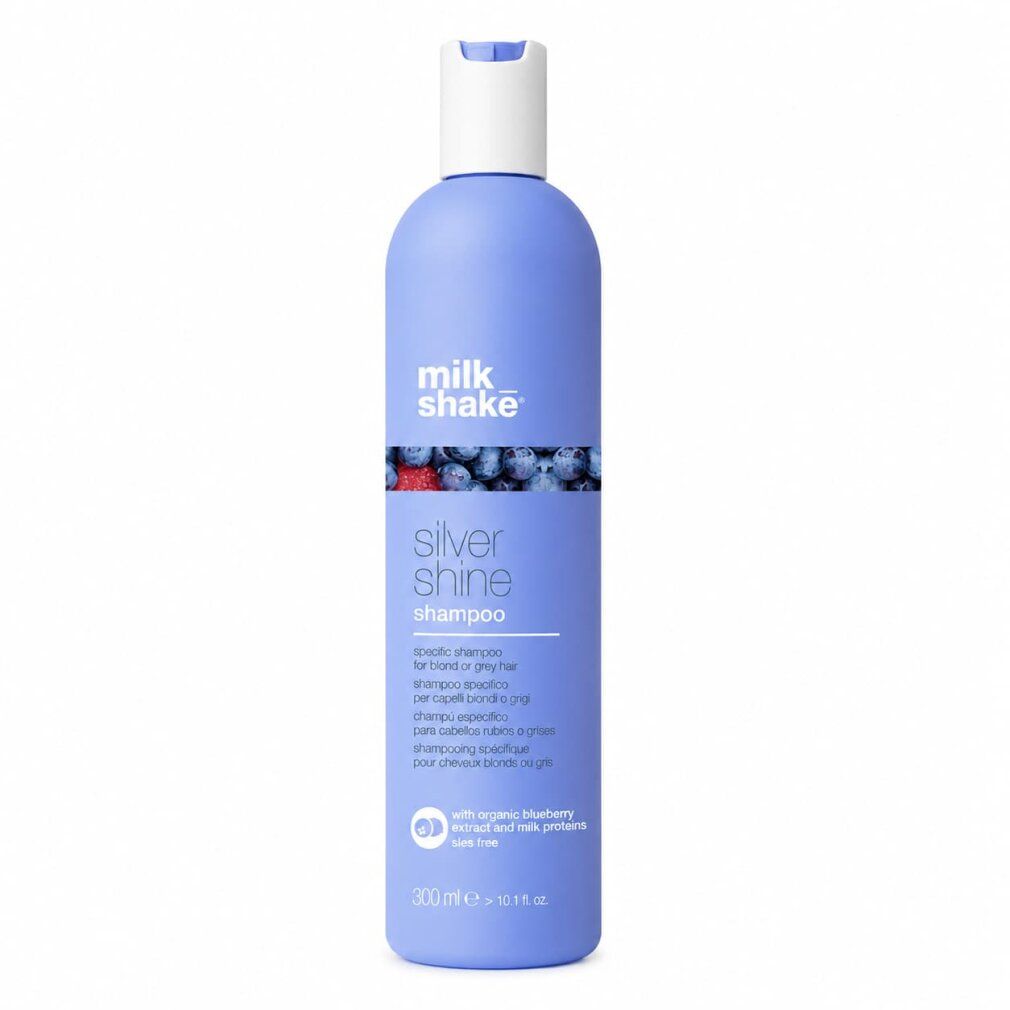 Shampoo Milk Shake Silver Shine in flacone viola con tappo bianco. Include immagini di mirtilli e fragole.