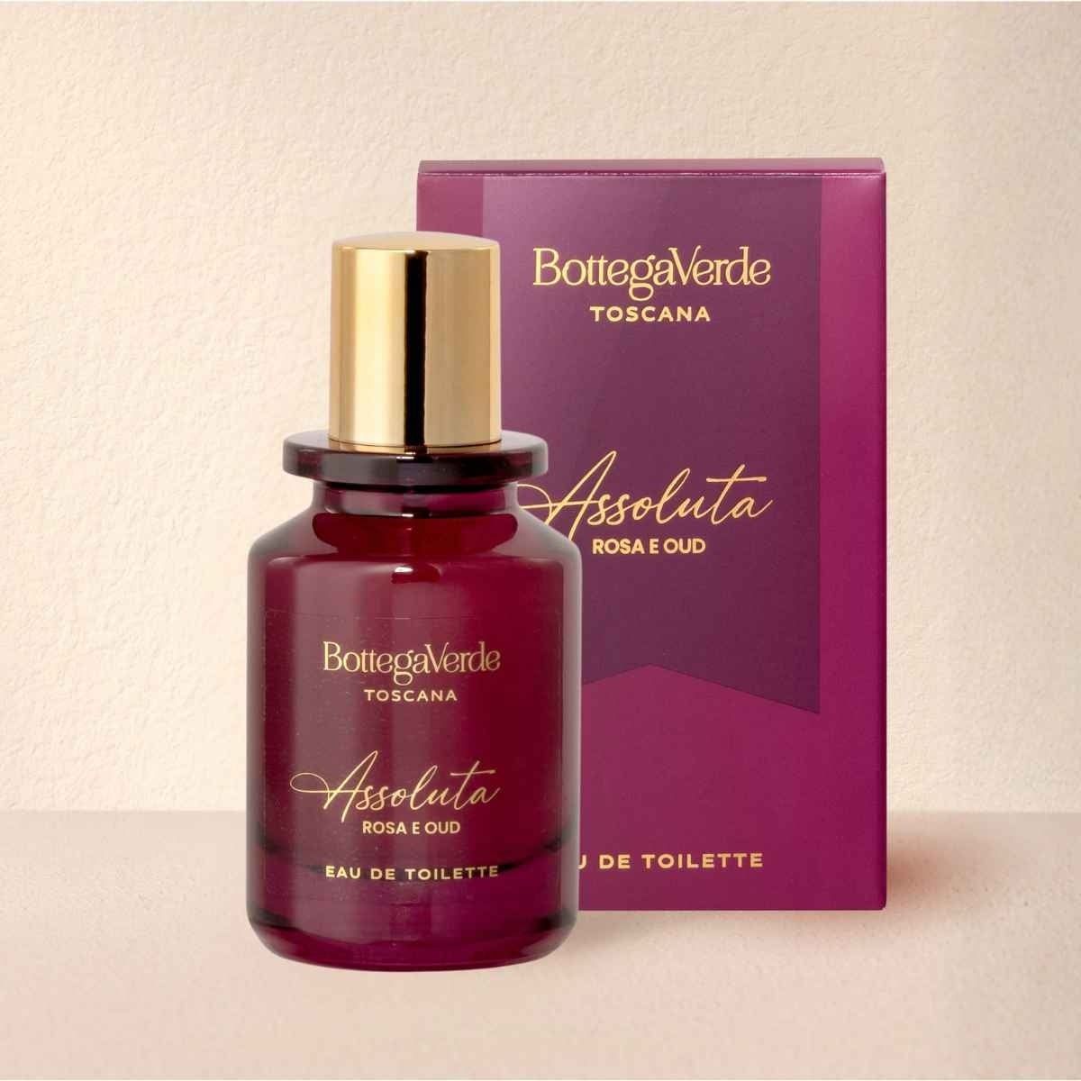 BottegaVerde Assoluta Eau de Toilette in flacone di vetro scuro con tappo dorato, accanto alla sua confezione viola abbinata.