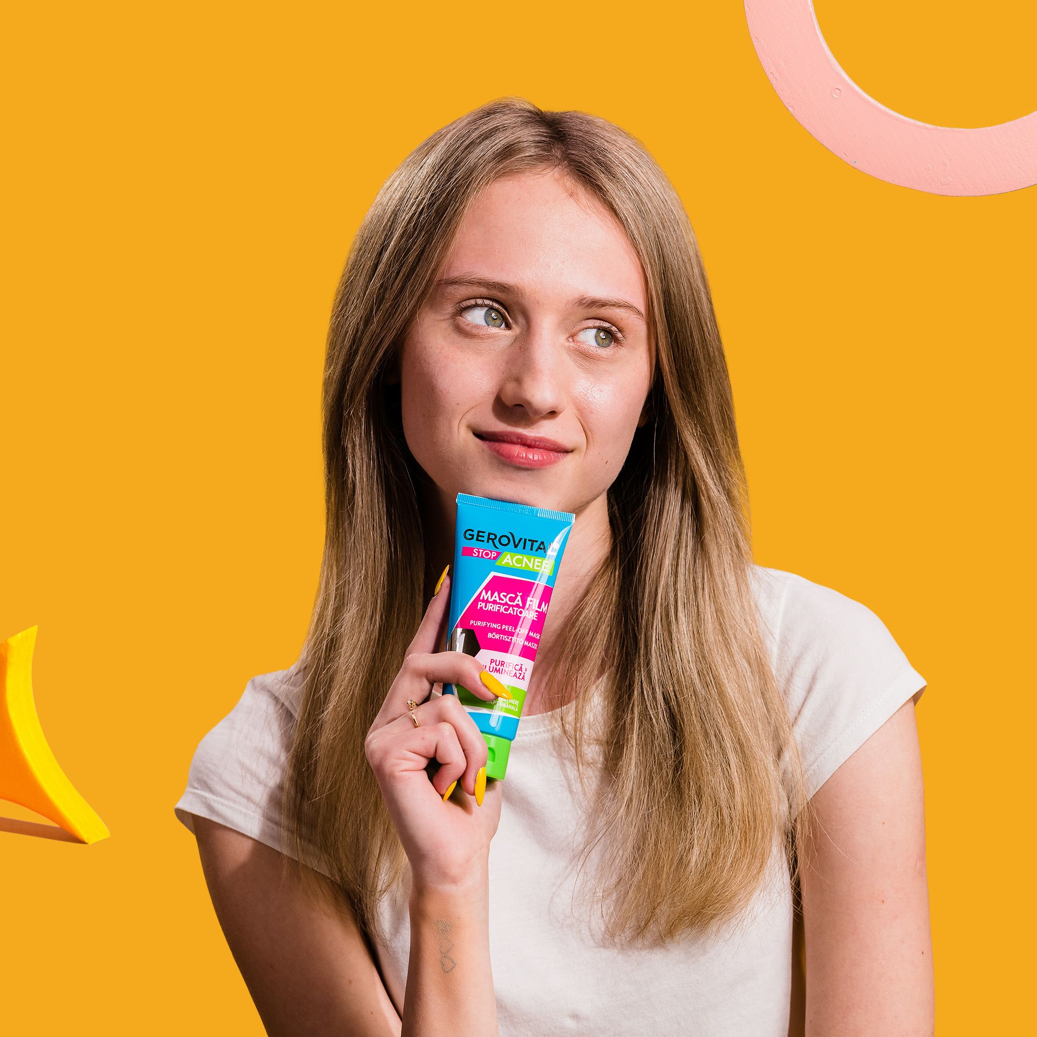 Donna che tiene un tubo blu-verde. Scritta: Gerovital Stop Acnee, Mască Film Purificatoare, Purifying Peel-off Maske.