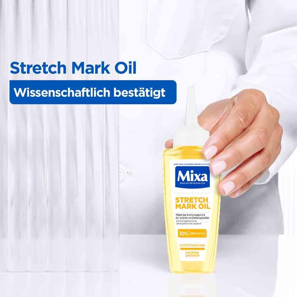 Flacone giallo Mixa Stretch Mark Oil. Scritta: Scientificamente provato. Persona che tiene il flacone.