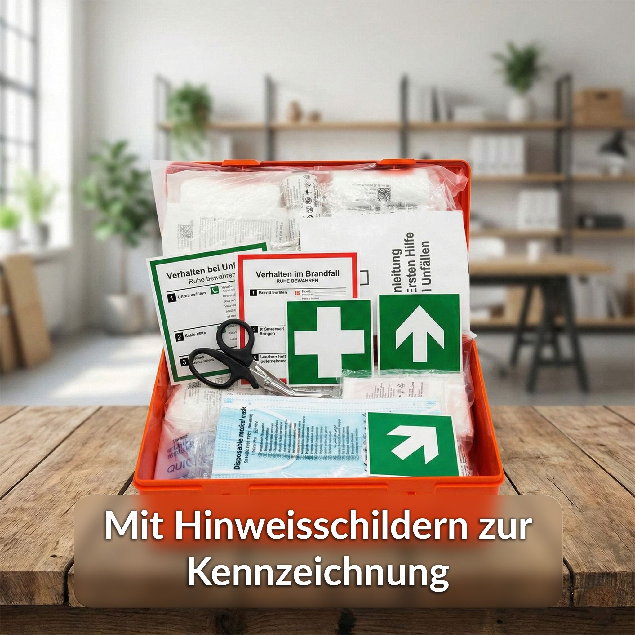 Cassetta di pronto soccorso rossa, aperta, con contenuto. Su un tavolo. Segnaletica per la marcatura.