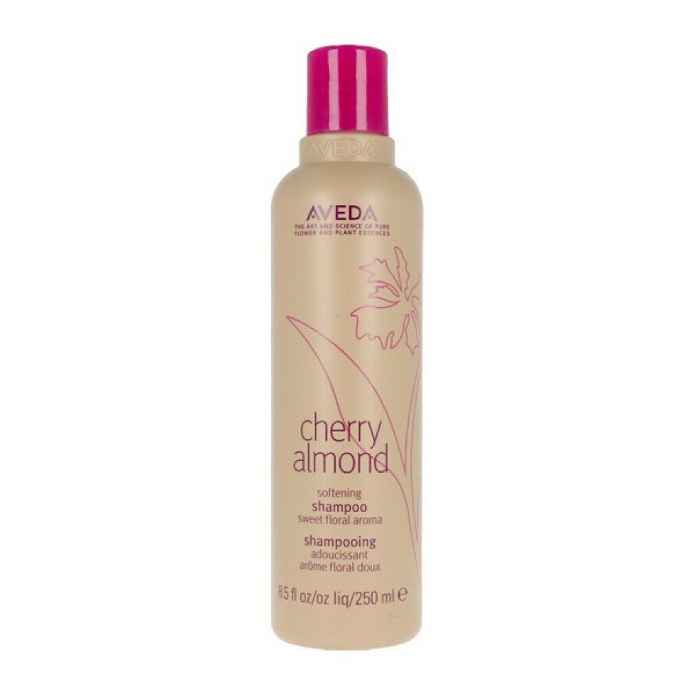 Piccolo flacone di shampoo beige con tappo rosa. Scritta: Aveda, Cherry Almond, Shampoo. Design floreale.