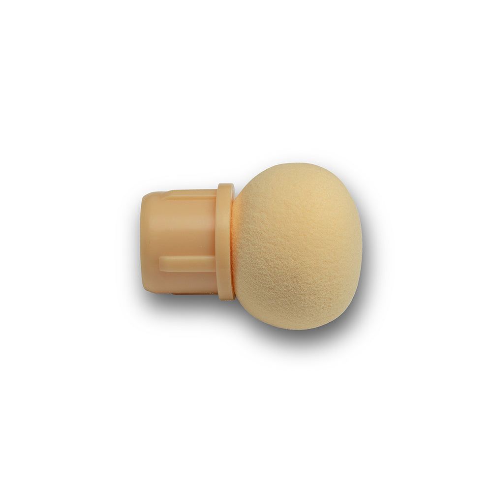 Applicatore per unghie beige con punta in spugna rotonda e base cilindrica.