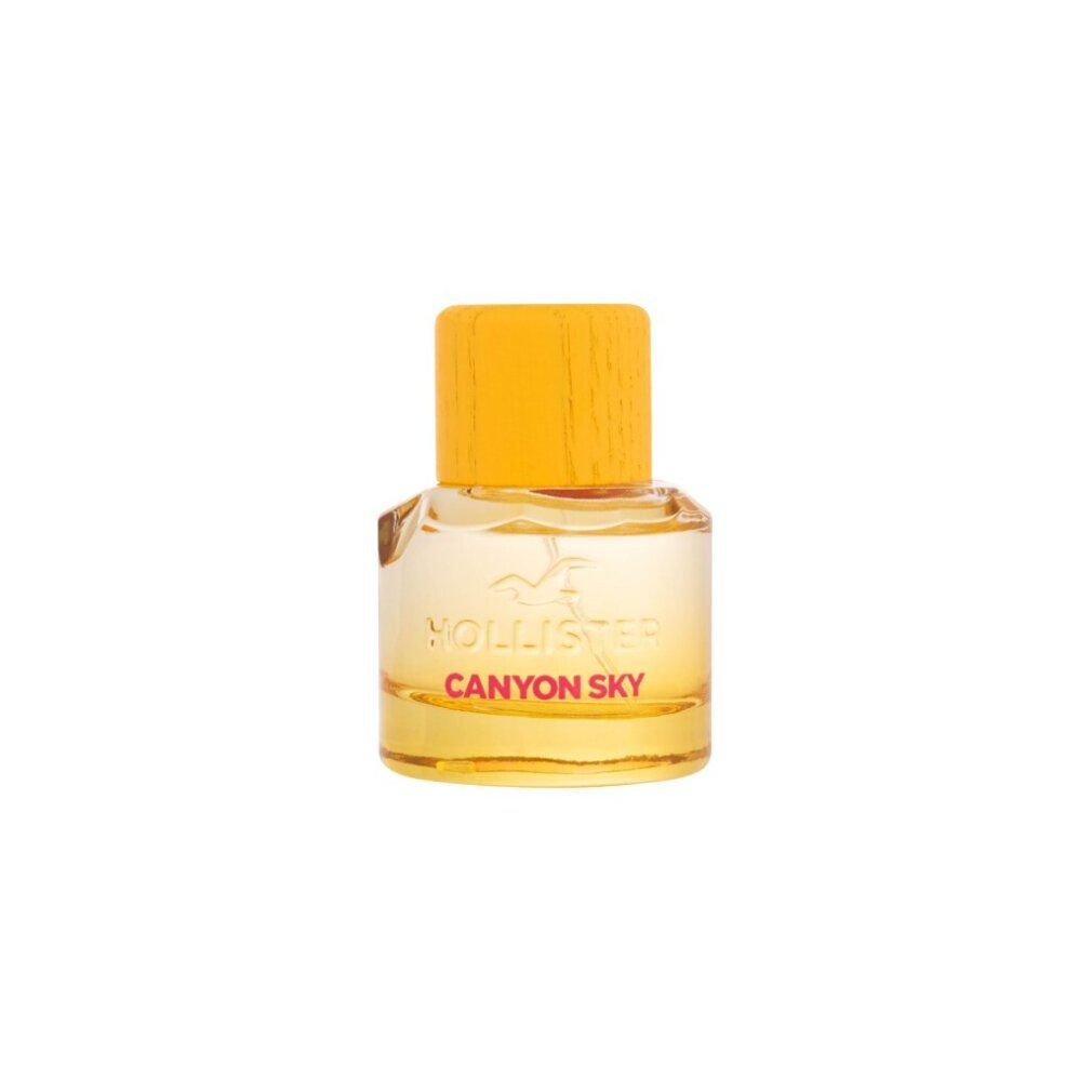 Flacone di profumo con tappo giallo. Flacone in vetro con liquido giallo e scritta Canyon Sky.