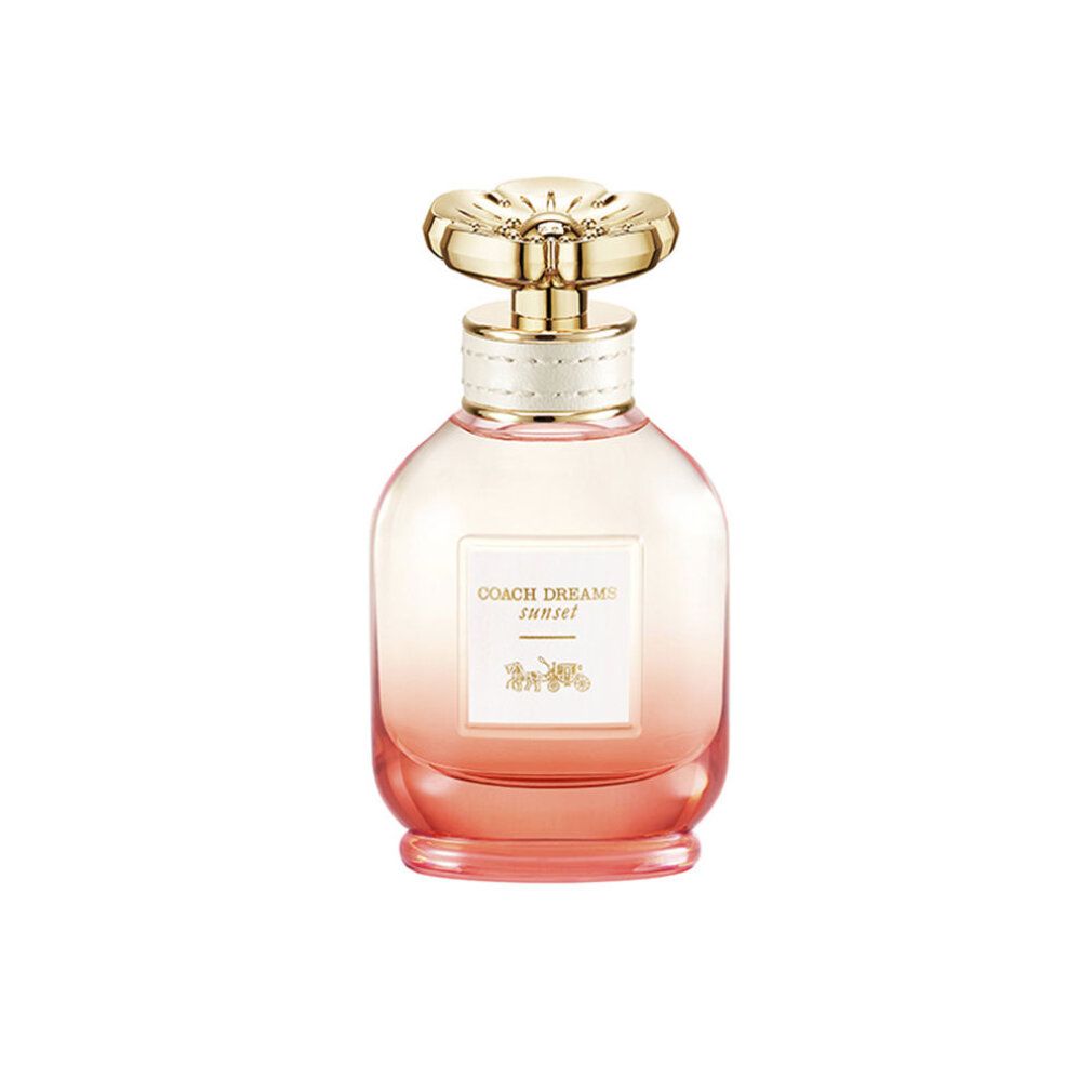 Flacone di profumo con tappo dorato e sfumatura rosa. L'etichetta riporta "COACH DREAMS sunset".