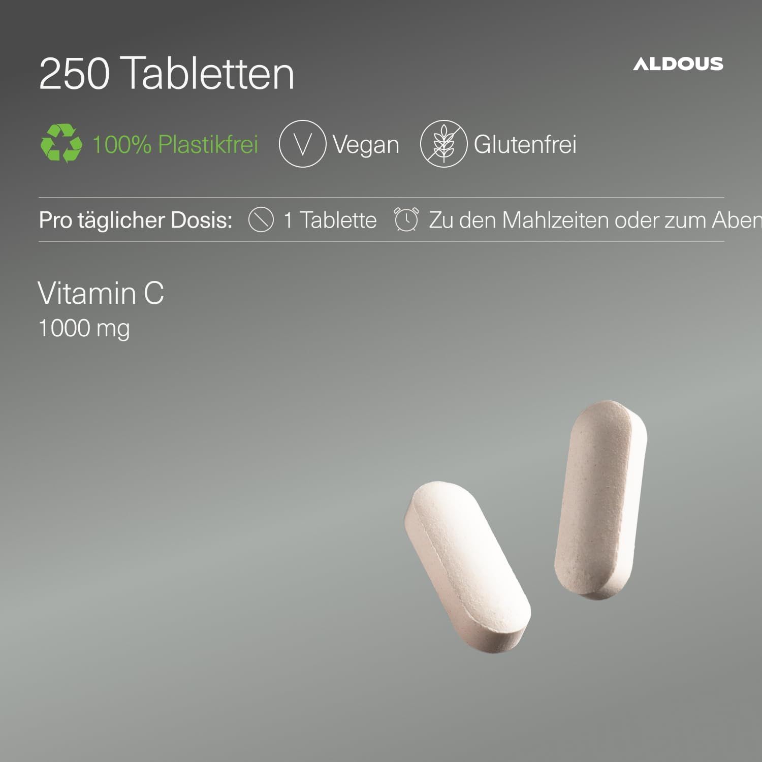 Due compresse Aldous Vitamina C 1000mg su sfondo grigio. Quantità confezione 250 compresse. Vegano, senza glutine, senza plastica.