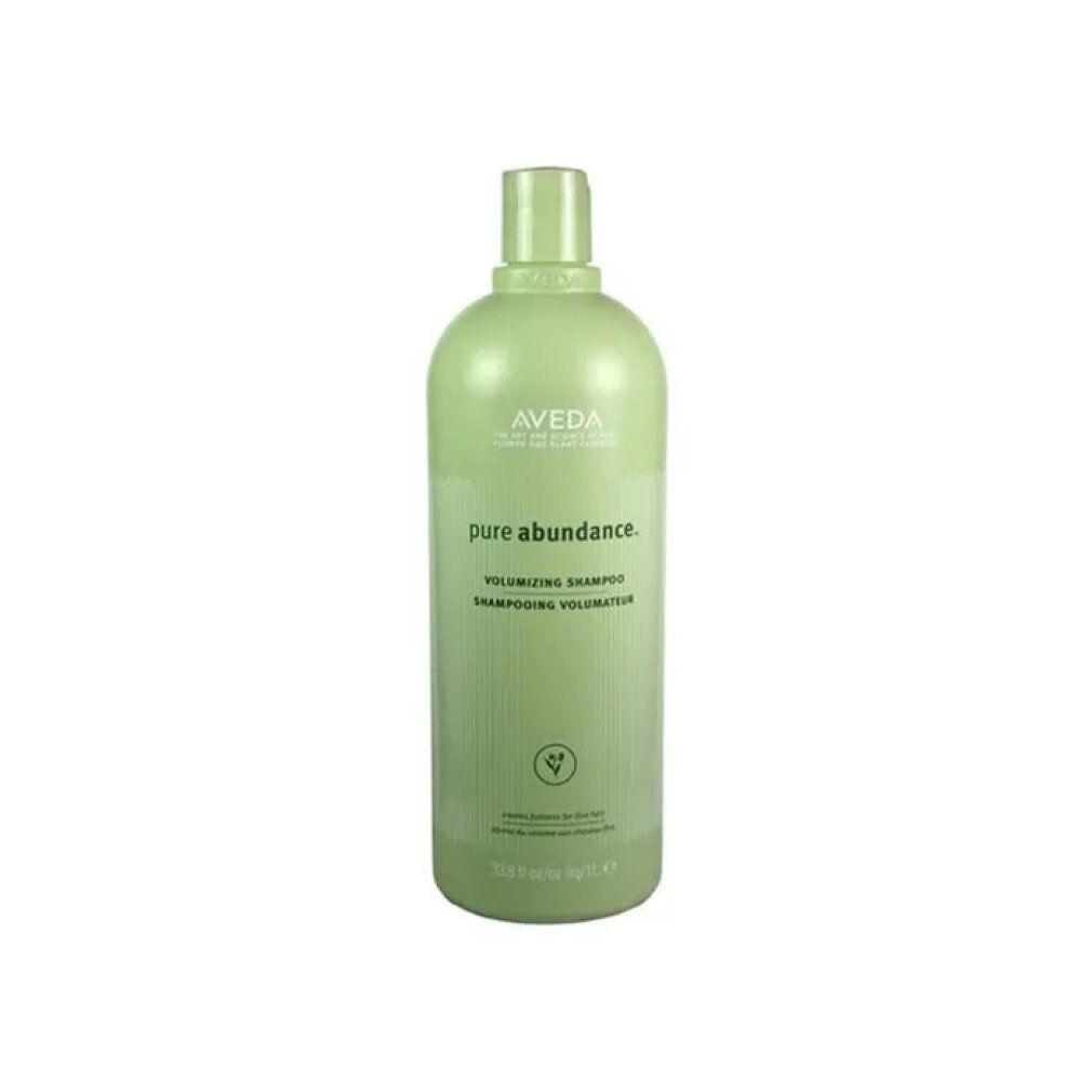Flacone verde con logo Aveda e nome del prodotto. Testo: Pure Abundance Volumizing Shampoo. Illustrazione vegetale verde.