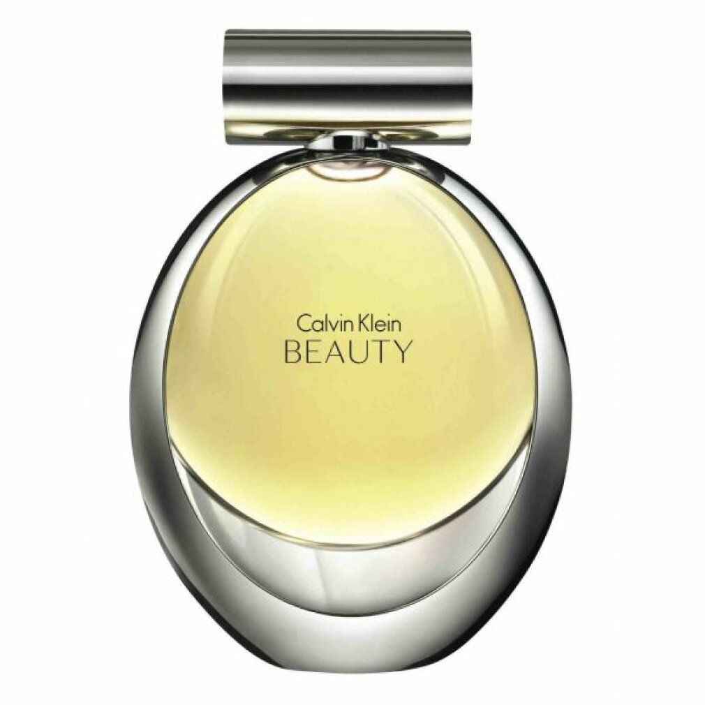Flacone di profumo rotondo con tappo argentato. Liquido giallo all'interno. Scritta Calvin Klein BEAUTY.