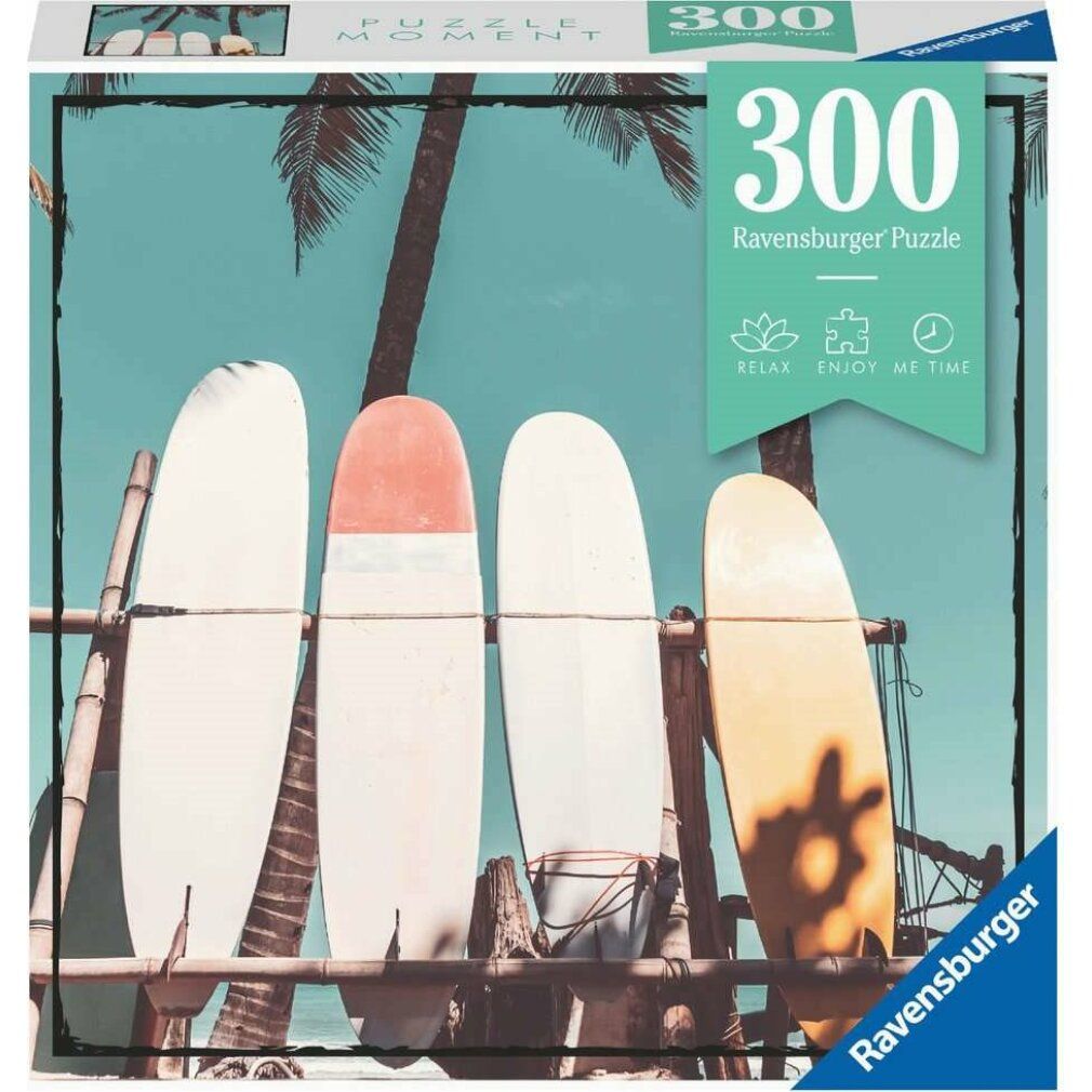 Scatola puzzle con tavole da surf davanti a palme. Scritta: 300 pezzi, Ravensburger.