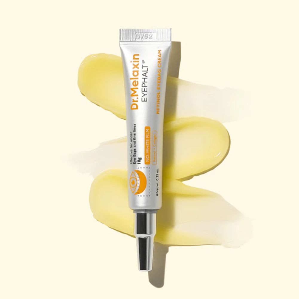 Tubo di crema con nome del prodotto e scritta. Contiene 10g. Con applicatore. Strisce di crema gialla sullo sfondo.