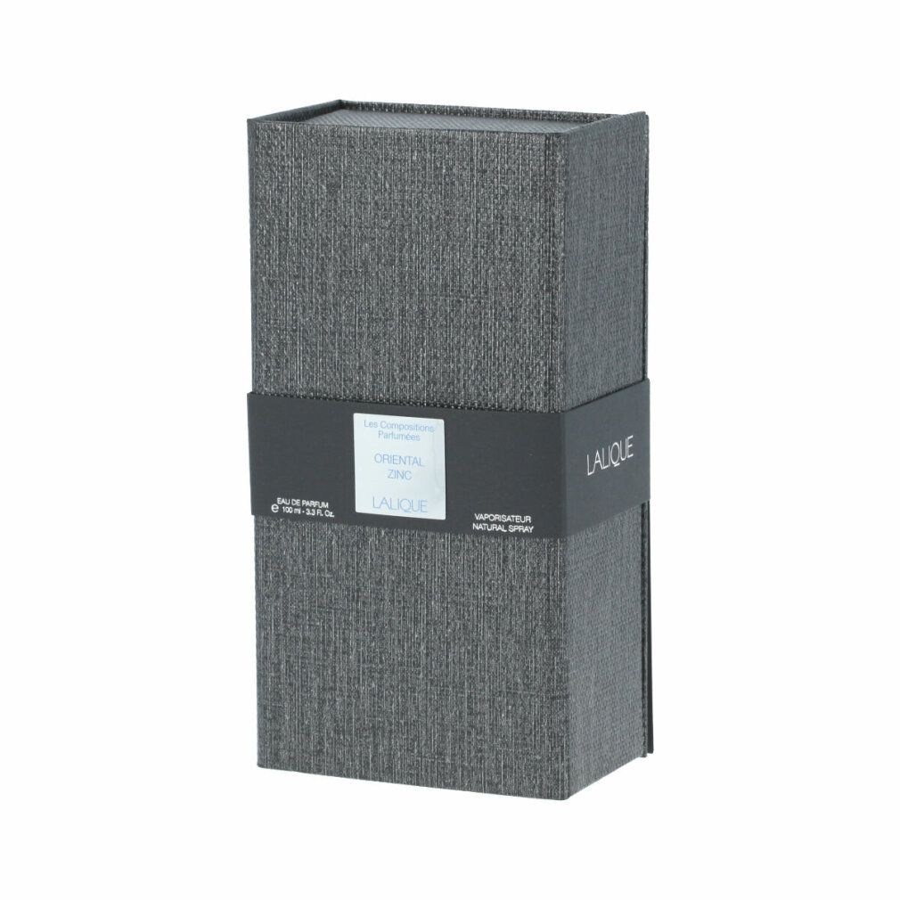 Scatola rettangolare grigia con fascia nera. Scritta: Oriental Zinc, Lalique. Eau de Parfum. Vapo. Natural Spray.