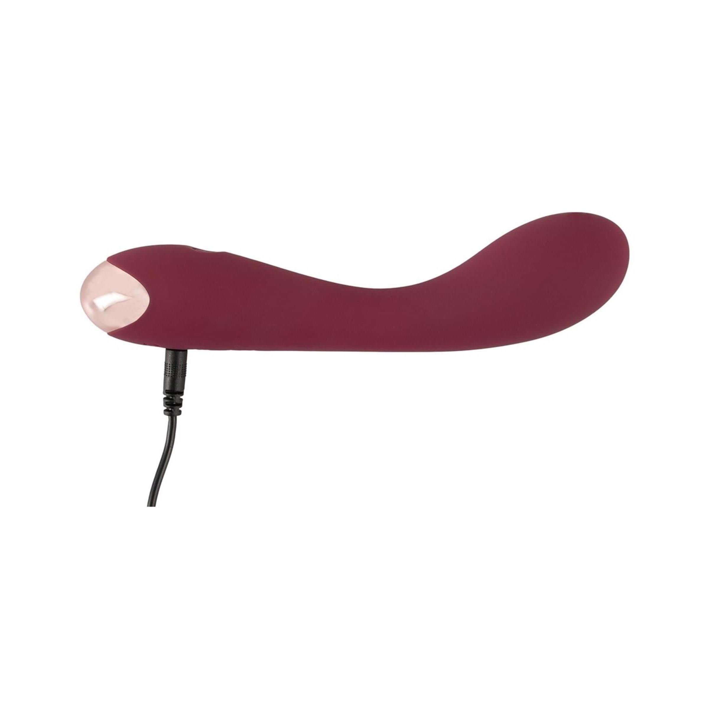 Vibratore bordeaux con porta di ricarica. Punta metallica visibile.