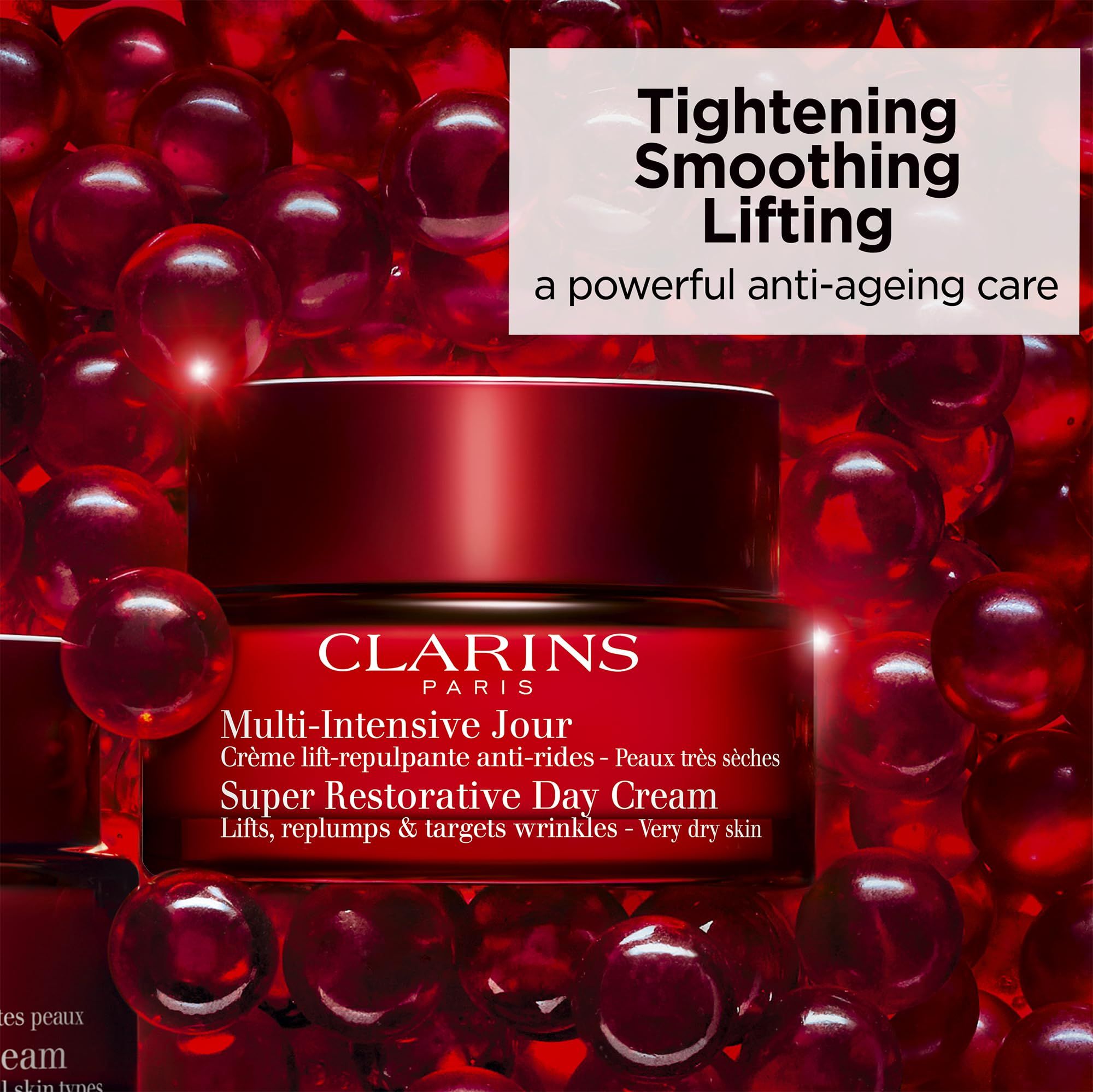 Vasetto rosso con crema. Testo: Clarins, Multi-Intensive Jour, Super Restorative Day Cream.