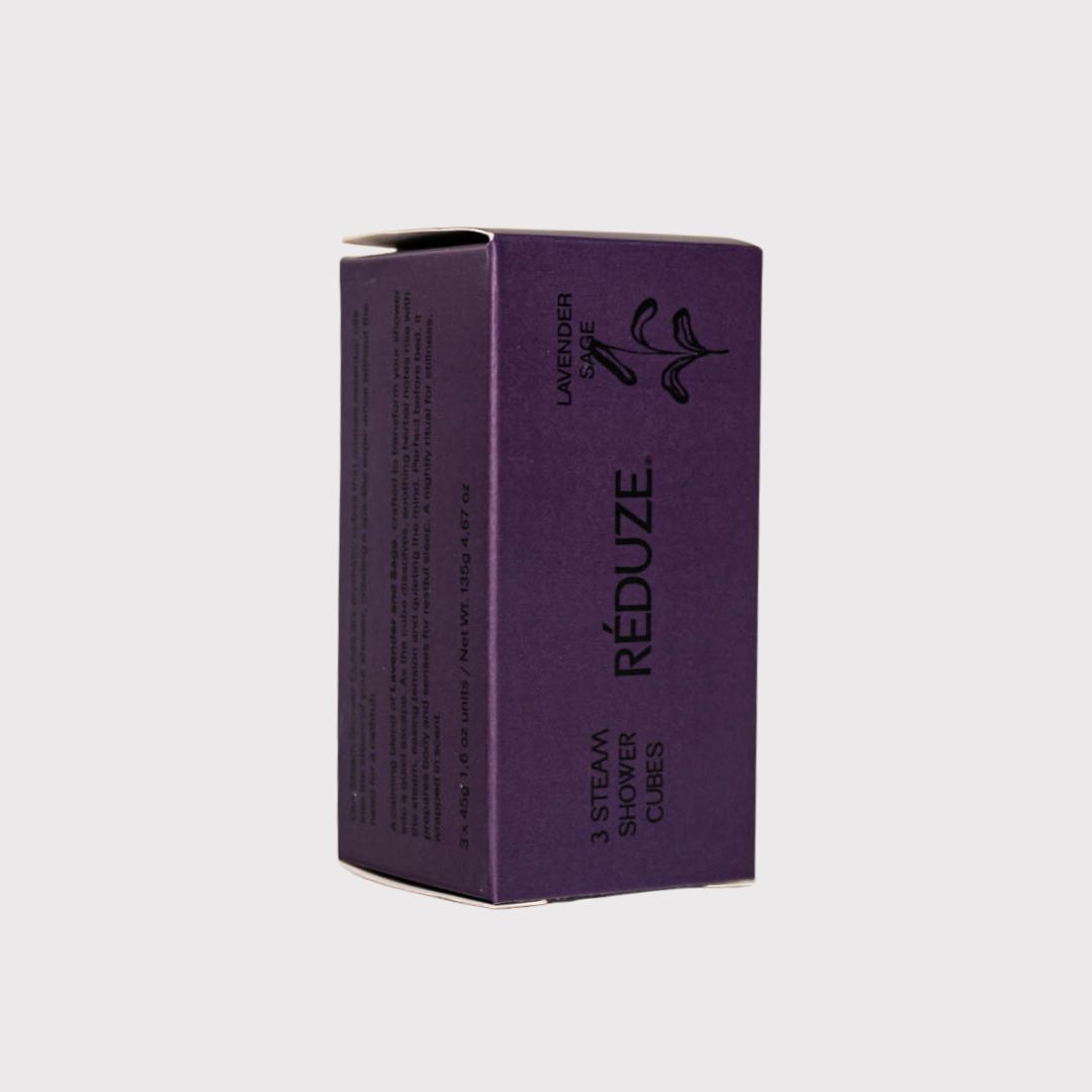 Scatola viola con logo RÉDUZE e testo. Scritta: 3 Steam Shower Cubes.