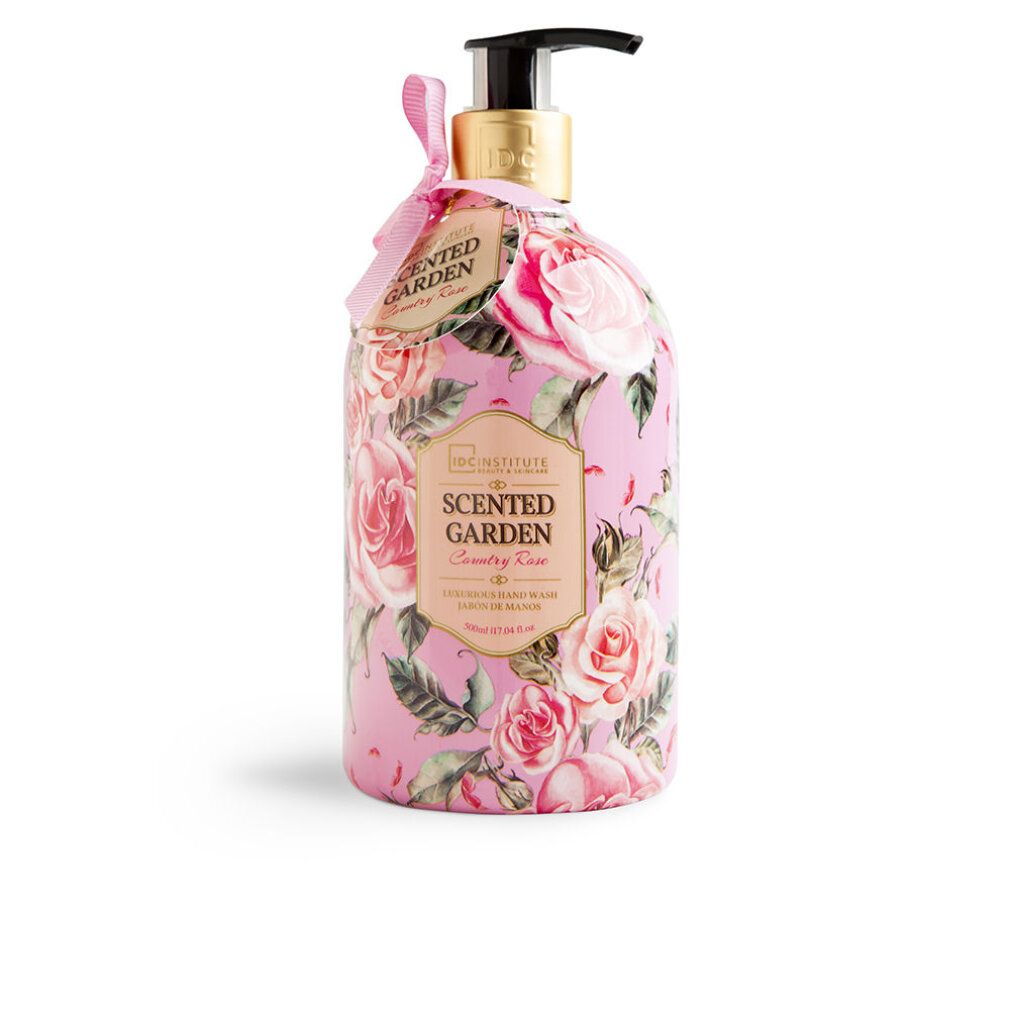 Sapone per le mani rosa con decorazioni floreali. Flacone con dosatore ed etichetta. Scritta: Scented Garden Country Rose. Marchio: IDC INSTITUTE.