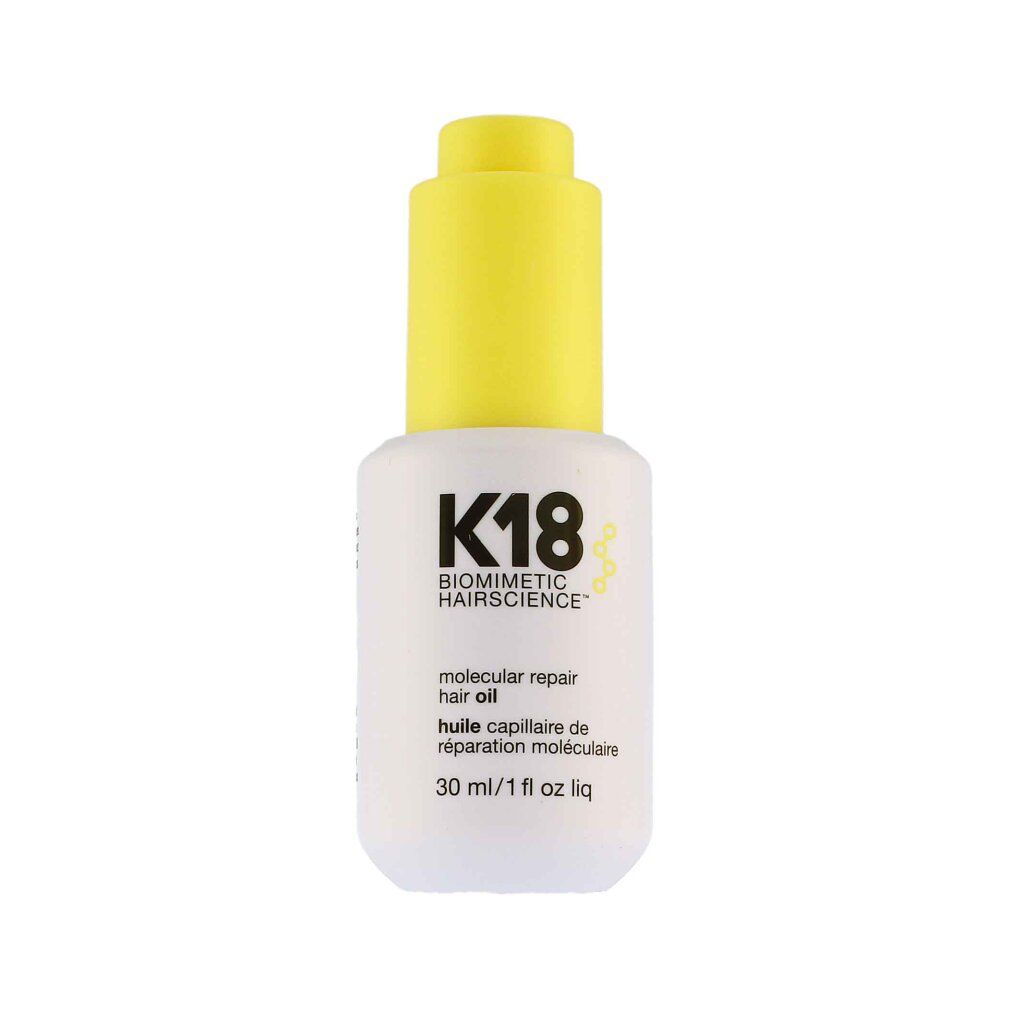 Flacone bianco con tappo giallo. Scritta: K18, molecular repair hair oil, 30 ml/1 fl oz liq.