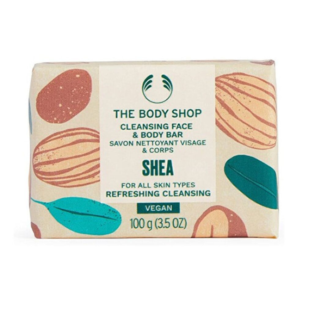 Sapone confezionato. Scritta: The Body Shop, Cleansing Face & Body Bar, Shea, Vegan. 100 g. Motivi marroni e verdi.