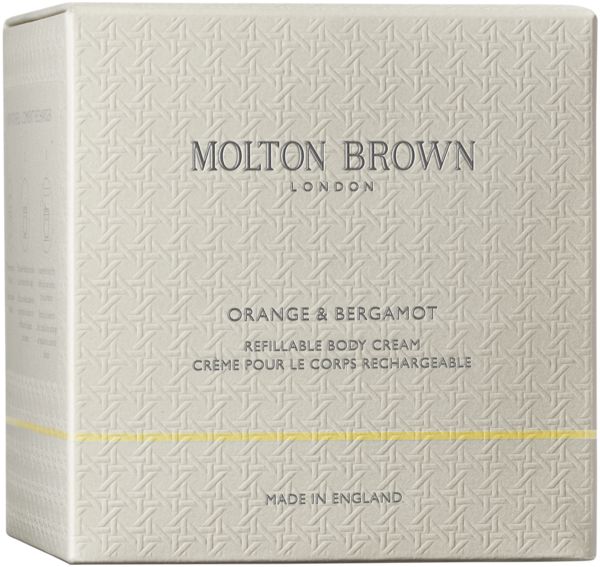 Vaso di vetro con coperchio argentato. Scritta: Molton Brown London. Contiene una crema bianca.