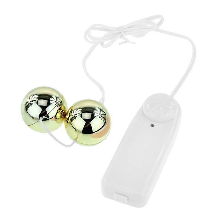 Vibratore dorato con due sfere e controller bianco, primo piano.