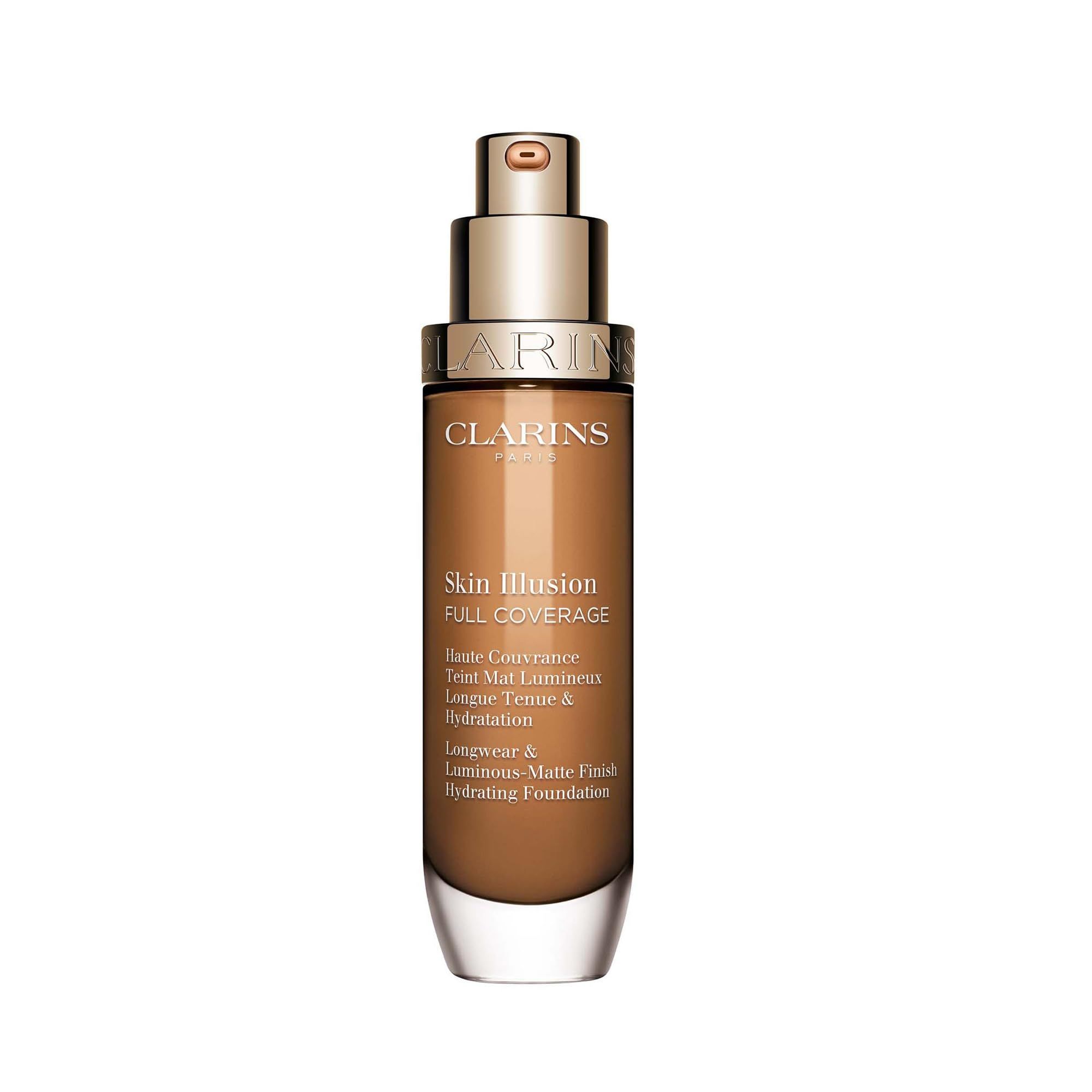 Flacone di fondotinta Clarins Skin Illusion, marrone con erogatore dorato. Testo: Skin Illusion Full Coverage, Longwear & Luminous-Matte Finish.