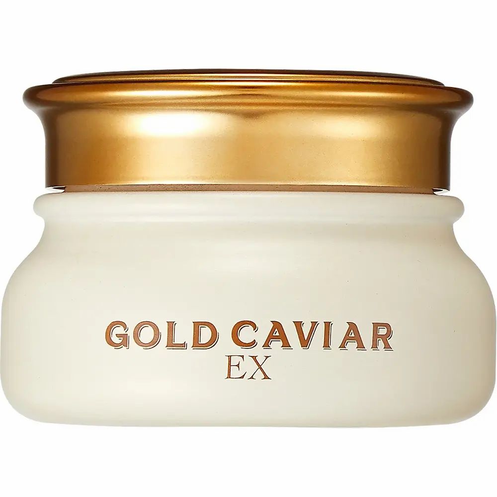 Vaso di crema con coperchio dorato. Scritta: GOLD CAVIAR EX. Contenitore color crema con coperchio dorato.