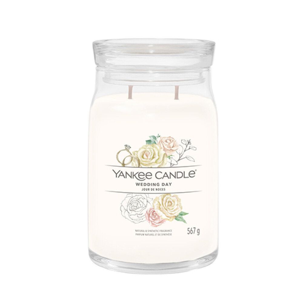 Vaso di vetro con coperchio, contenuto color crema ed etichetta. Scritta: Yankee Candle, Wedding Day, 567 g.