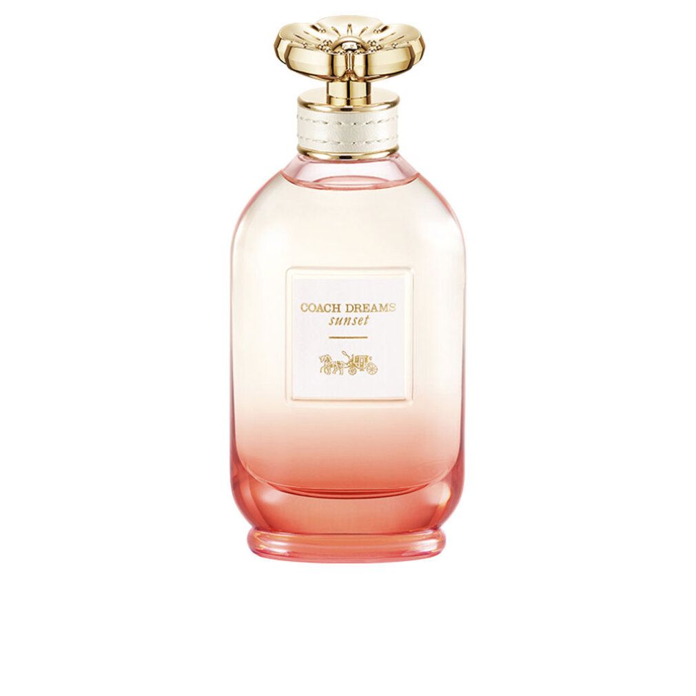 Flacone di profumo con tappo dorato. Etichetta "Coach Dreams Sunset" e logo carrozza. Sfumatura da rosa ad arancione.