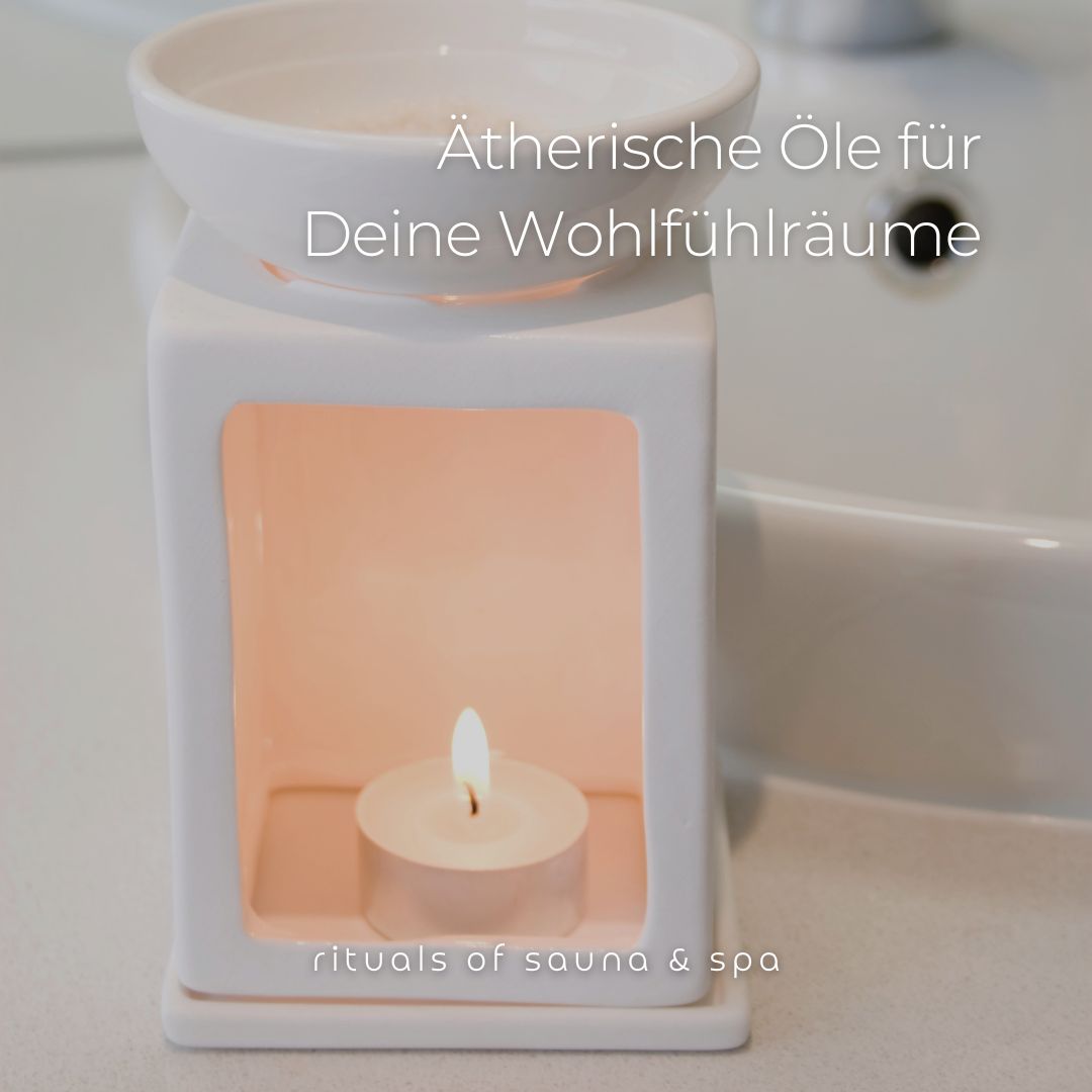 Diffusore di aromi bianco con una candela accesa all'interno. Scritta: rituals of sauna & spa.