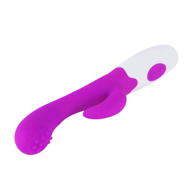 Vibratore viola e bianco con punta a coste, visto in diagonale dall'alto.