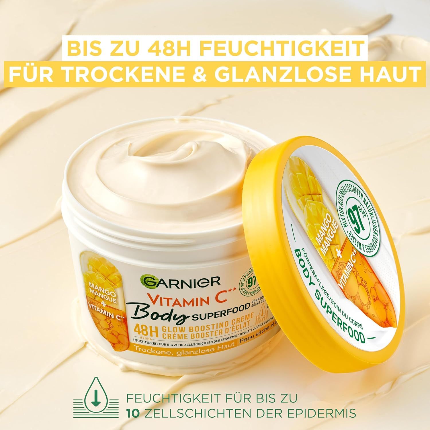 Vasetto bianco con coperchio giallo. Scritta: Garnier Vitamin C Body Superfood. Immagine mango. Testo: 48h idratazione per pelle secca.