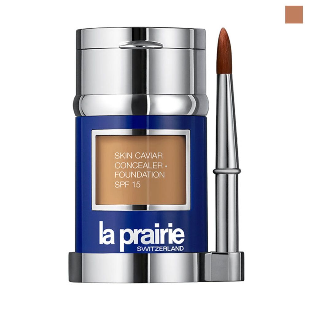 Contenitore blu-argento con contenuto marrone e pennello. Scritta: Skin Caviar Concealer Foundation SPF 15, La Prairie.