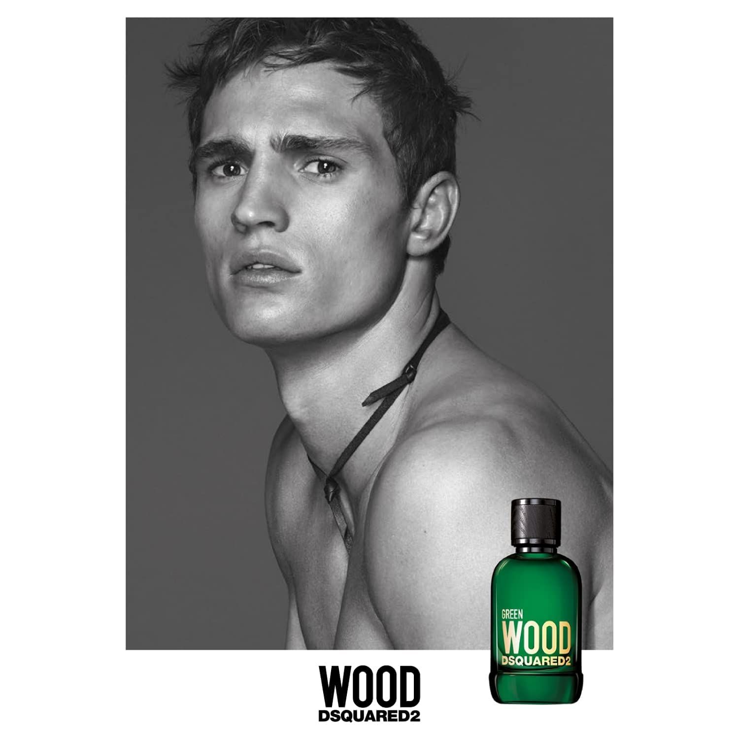 Foto in bianco e nero di un uomo. In basso a destra: flacone verde con scritta GREEN WOOD DSQUARED2.