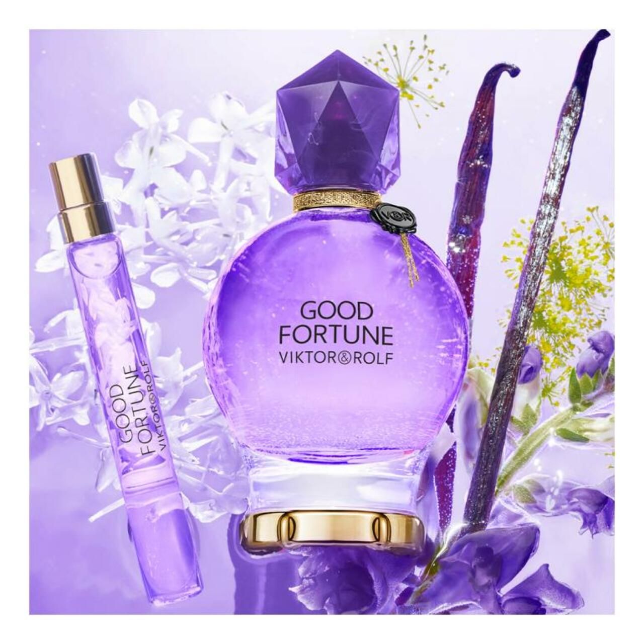 Flacone e vaporizzatore con fiori e spezie. Flacone rotondo con tappo di cristallo. Scritta: Good Fortune Viktor & Rolf.