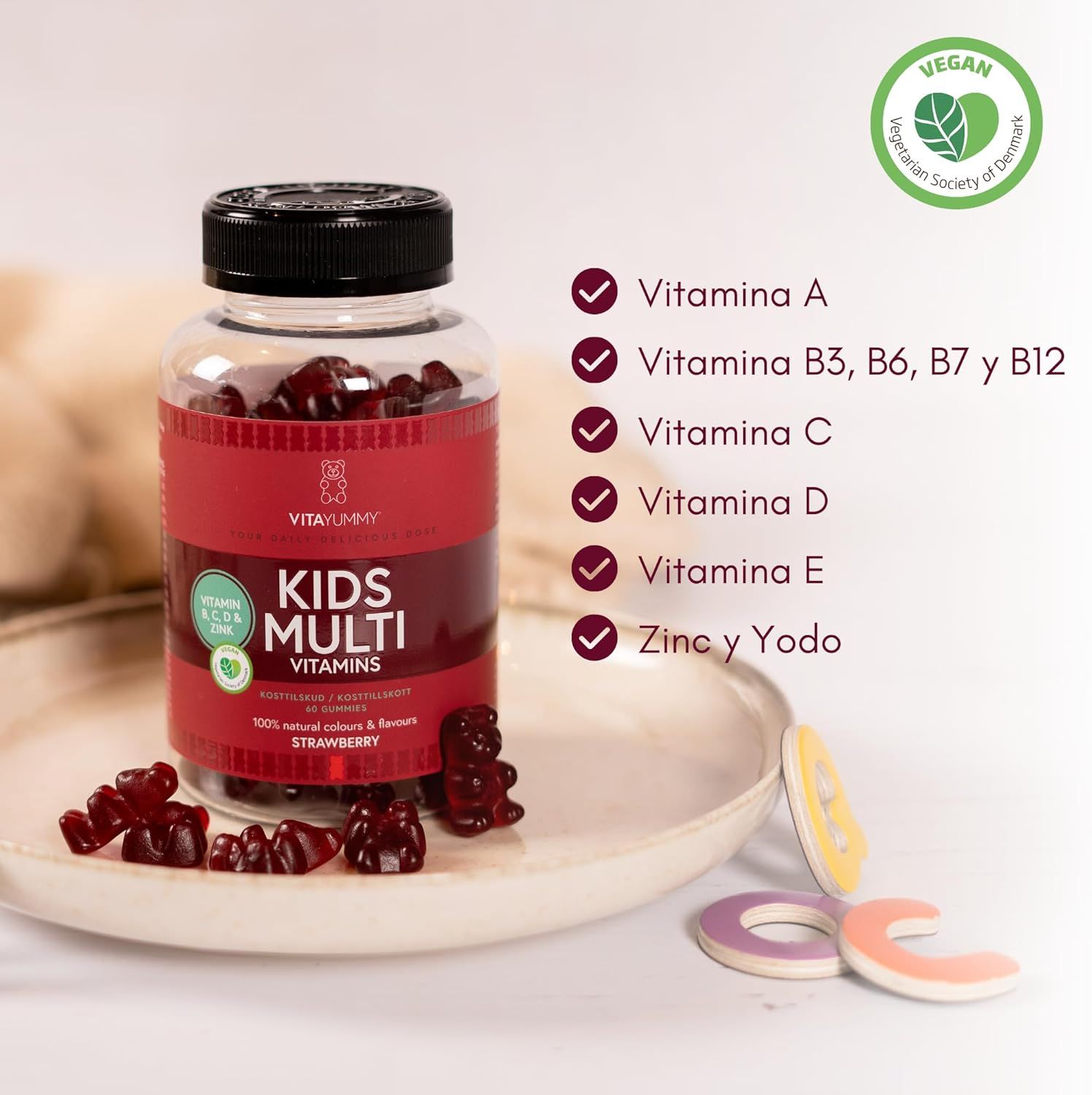 Bottiglia di orsetti gommosi rossi. Scritta: KIDS MULTI VITAMINS. Contiene vitamine A, B3, B6, B7, B12, C, D, E, zinco e iodio. Vegano.