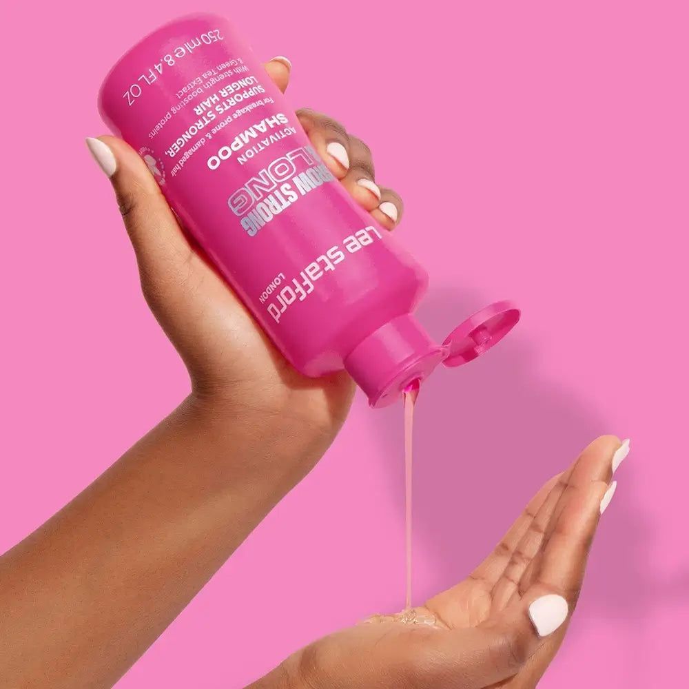 Mano che versa shampoo attivatore LEE STAFFORD Grow Strong & Long da una bottiglia.