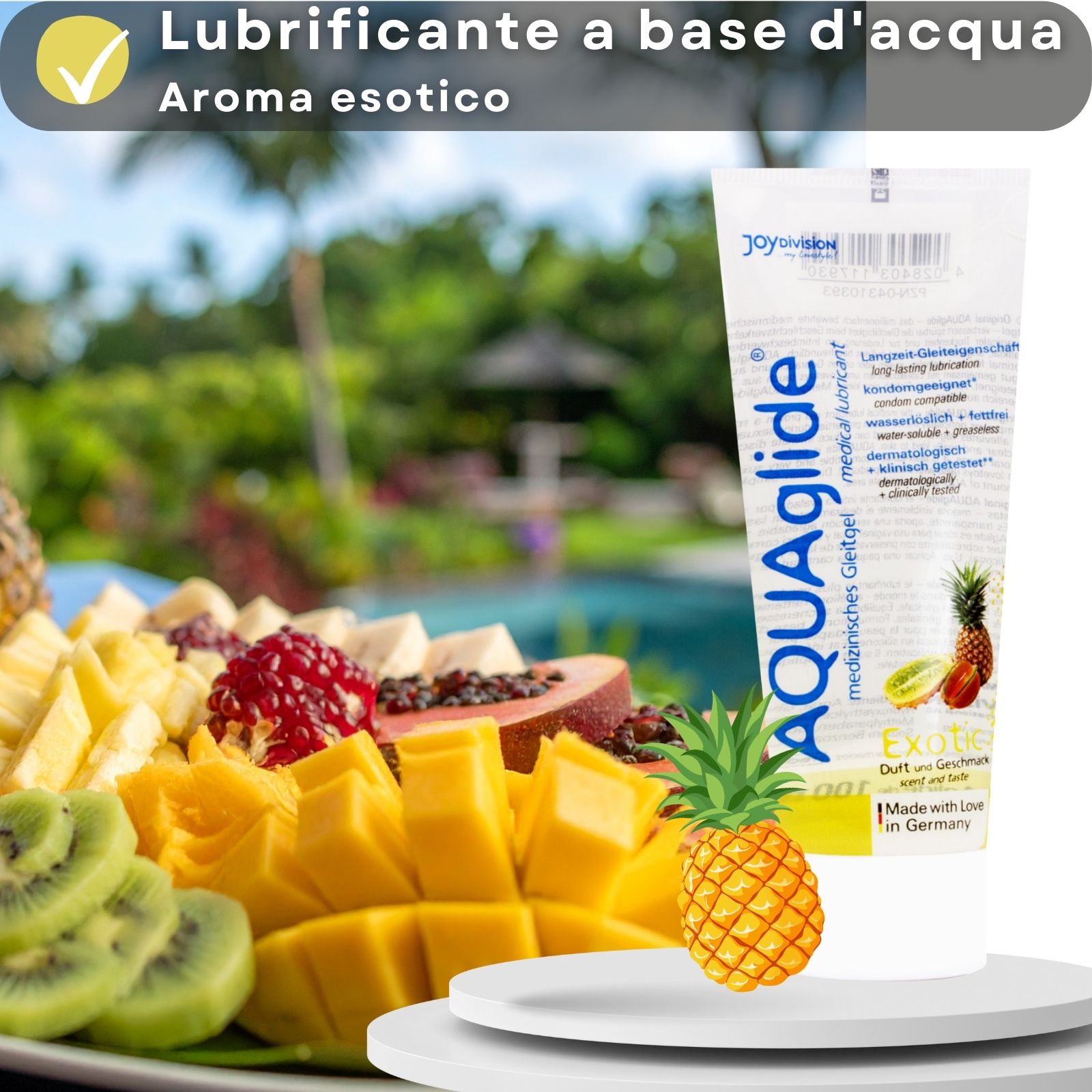 Tubo di gel lubrificante AQUAglide accanto a un piatto di frutta. Testo: A base d'acqua, gusto esotico. Con ananas e kiwi.