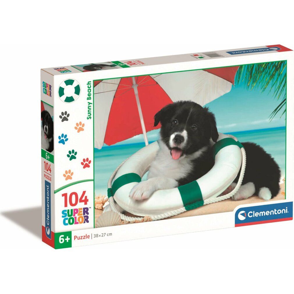 Scatola puzzle Clementoni con un cane in un salvagente sulla spiaggia. Contiene 104 pezzi, 6+.