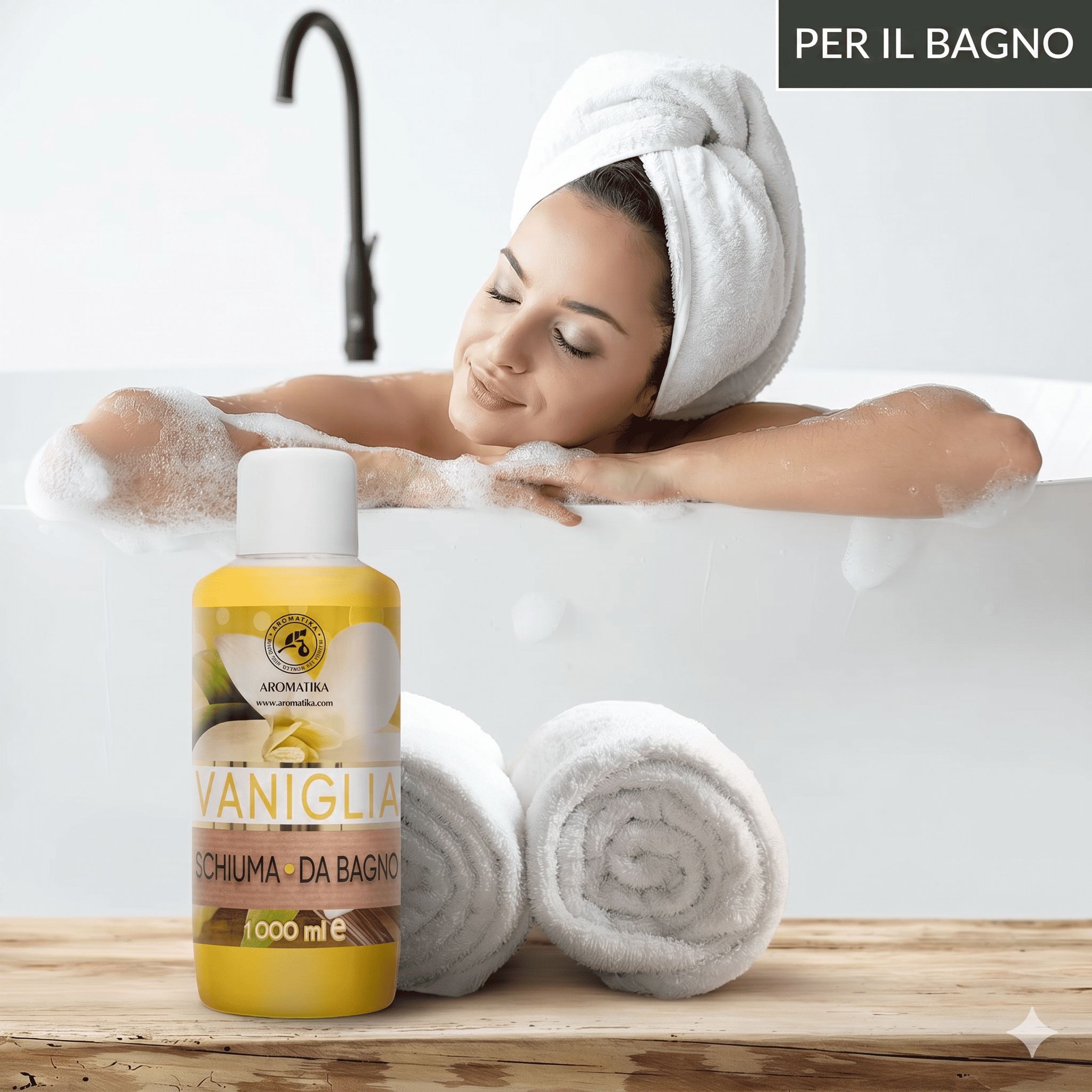 Donna in vasca da bagno con schiuma, accanto a un flacone di bagnoschiuma alla Vaniglia AROMATIKA.