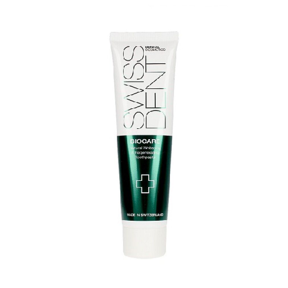 Tubo di dentifricio bianco e verde. Scritte: SWISSDENT, BIOCARE, Natural Whitening & Regenerating Toothpaste. Croce verde.