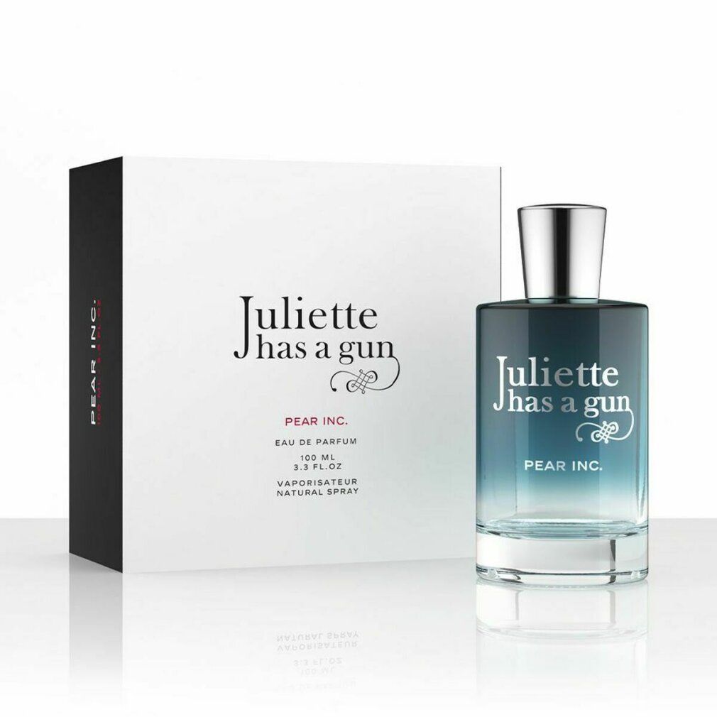 Flacone di profumo accanto a scatola bianca. Scritta: Juliette has a gun, Pear Inc. Flacone con sfumatura blu-trasparente.