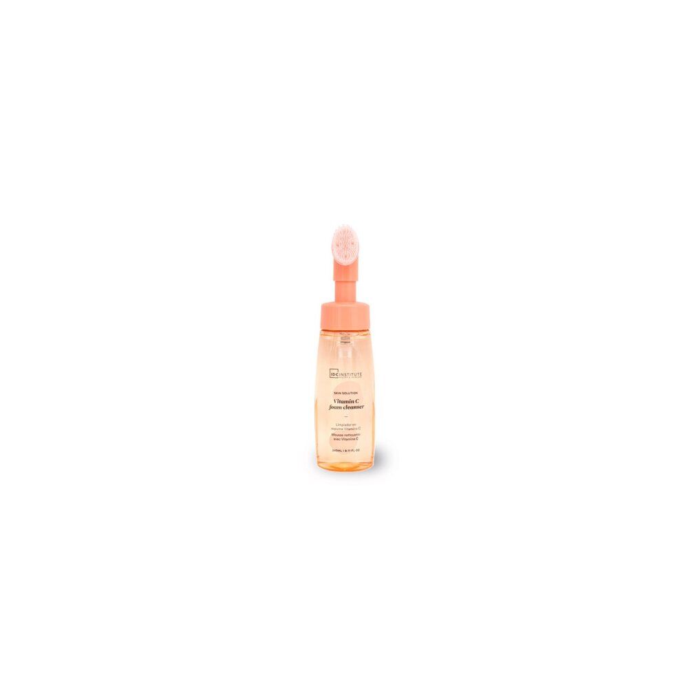 Flacone di schiuma detergente alla vitamina C con applicatore a spazzola integrato.