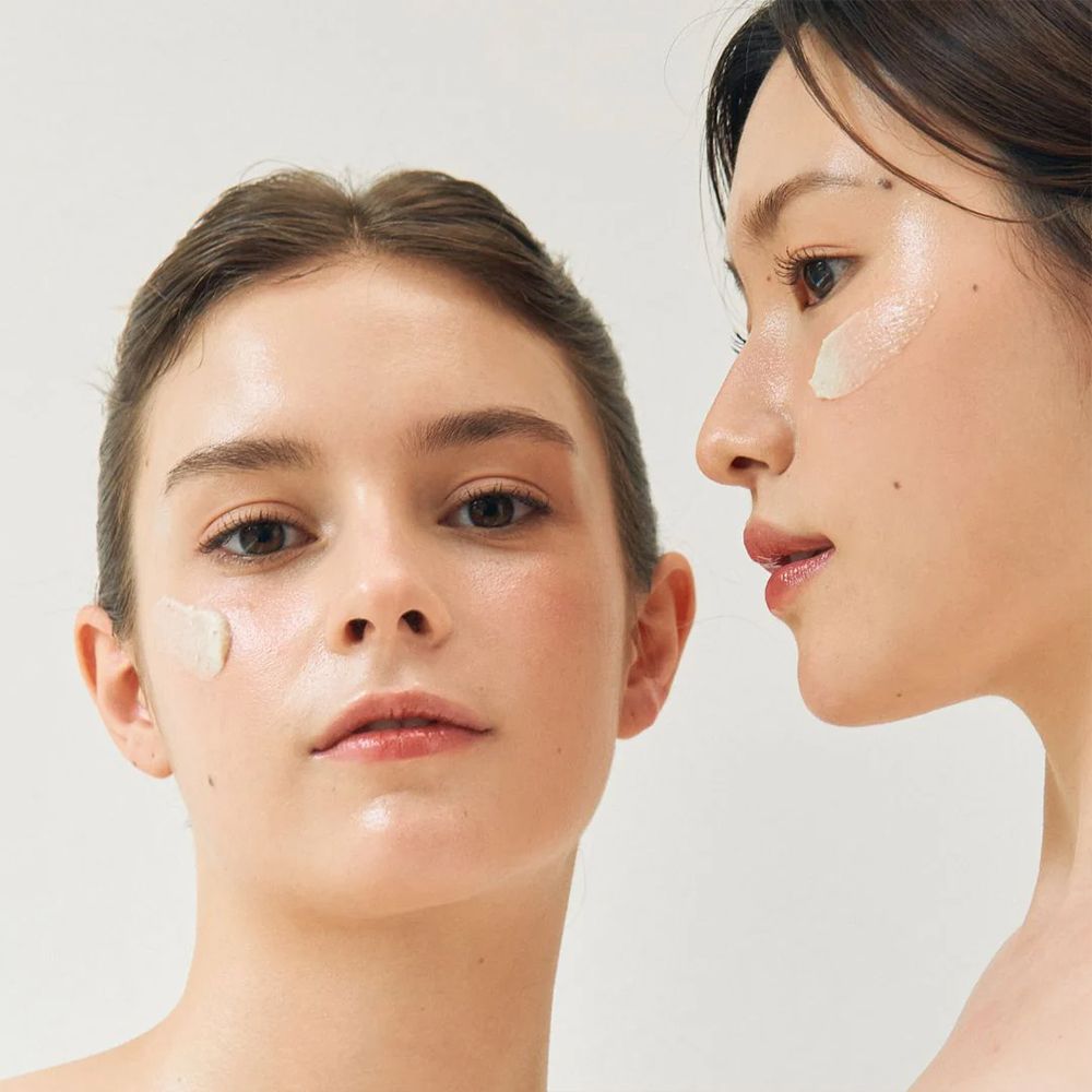 Due donne con la maschera BEAUTY OF JOSEON Ground Rice and Honey Glow Mask sulle guance.