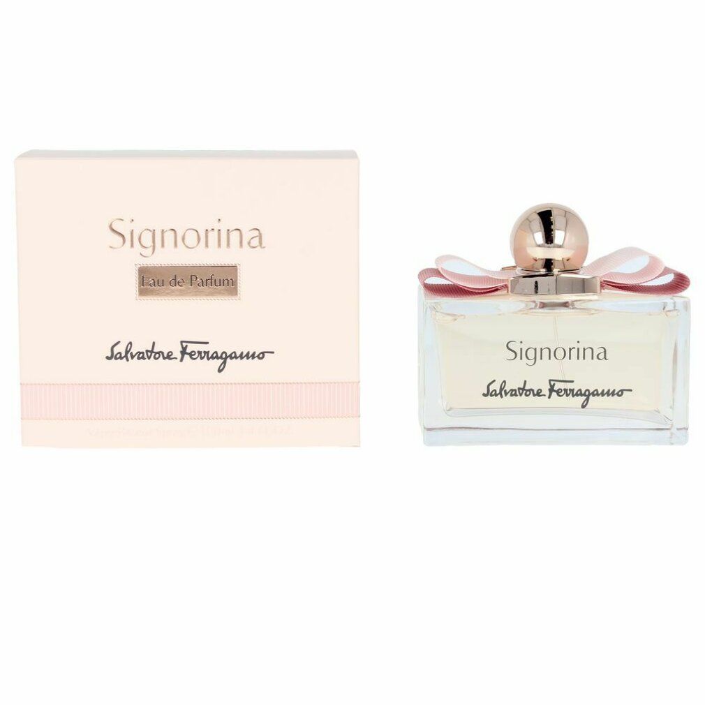 Flacone di profumo Signorina Eau de Parfum. Flacone rettangolare in vetro con liquido rosa. Fiocco rosa e tappo dorato. Scatola accanto.