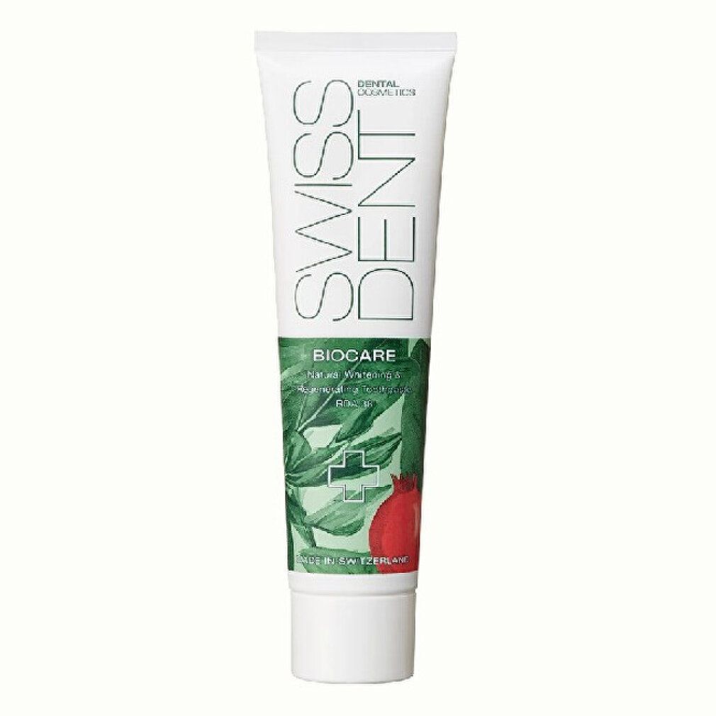 Tubo di dentifricio Swissdent Biocare con motivo botanico e melograno rosso.