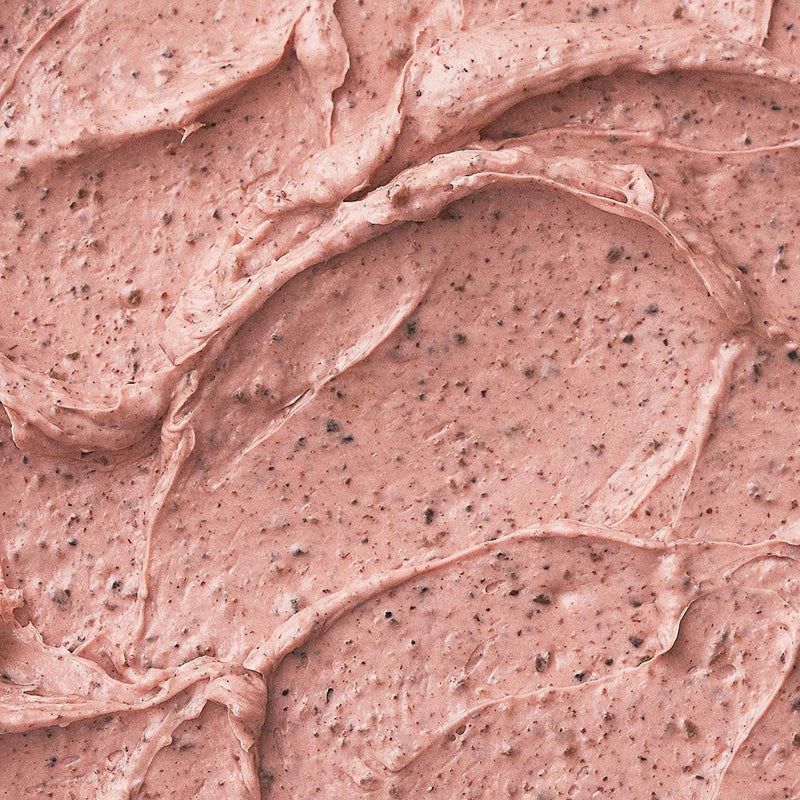 Primo piano della maschera viso rosa. Texture con particelle scure.