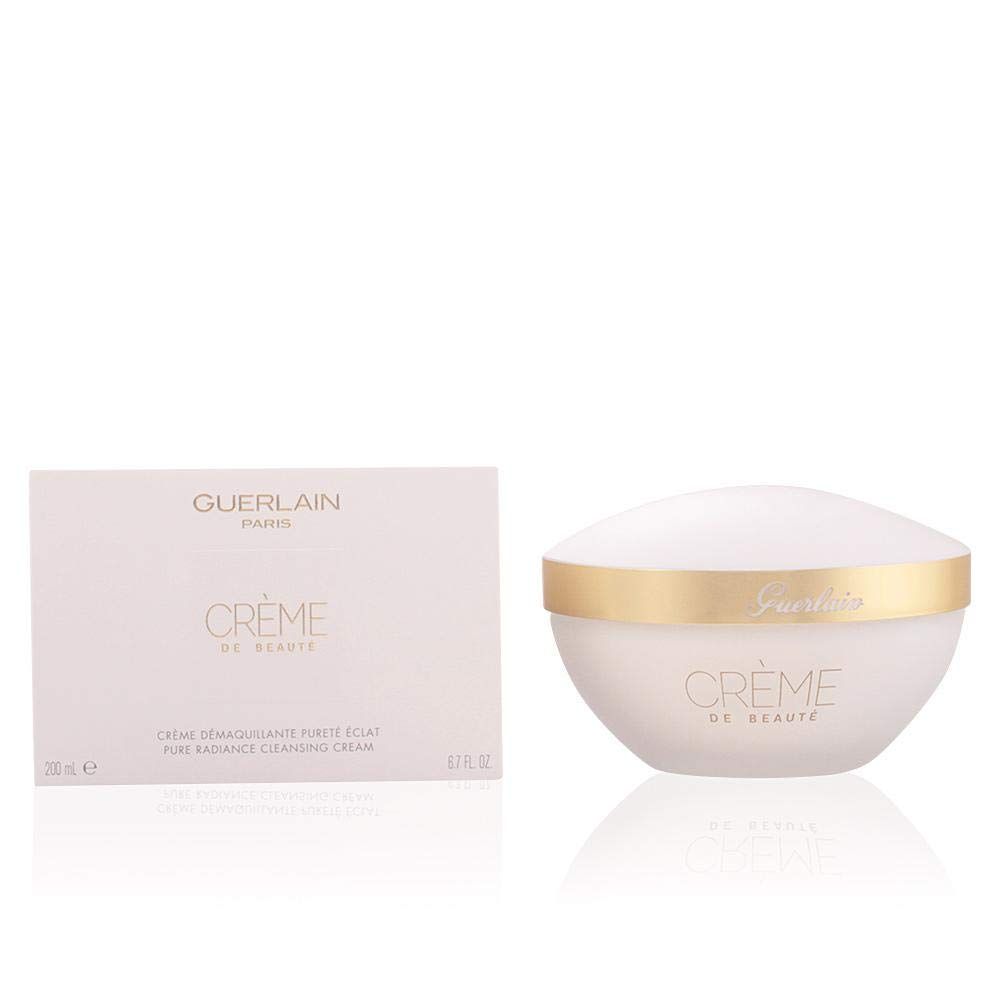 Vaso bianco con bordo dorato e scritta. Accanto, una confezione rettangolare. Scritta "Guerlain" visibile.