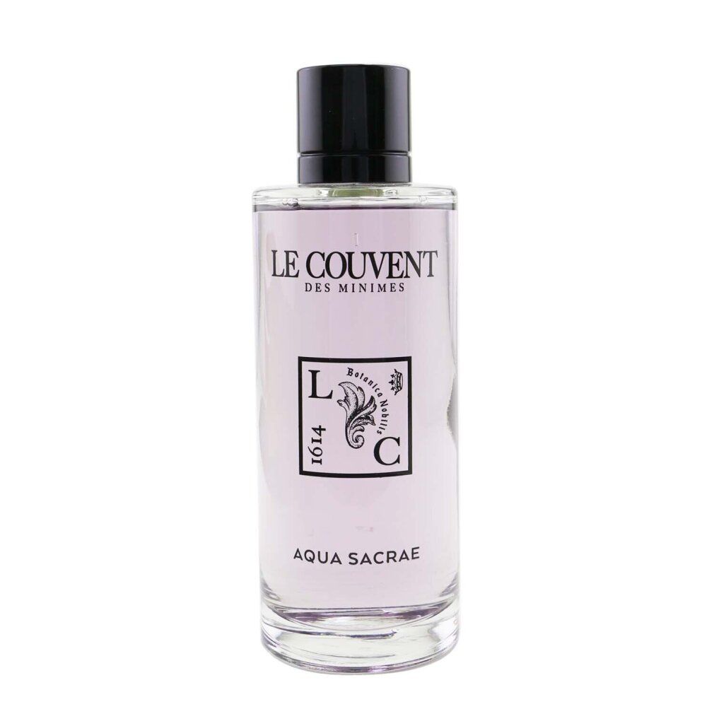 Flacone in vetro con tappo nero. Scritta: Le Couvent, Aqua Sacrae. Logo con elementi floreali e testo.